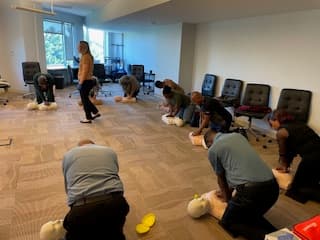 Learners practicing compressions on adult manikins.